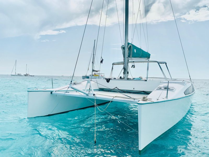 catamaran 28 front while anchored in the sea, all full of white color